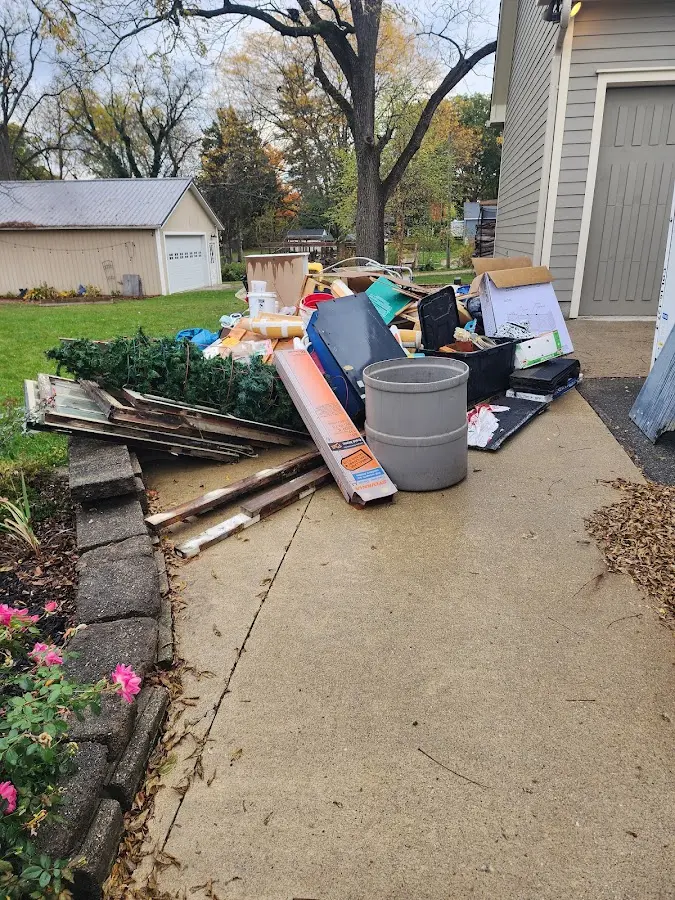 Dumpster being loaded with debris for 12 Yard Dumpster Rental in Pigeon Forge
